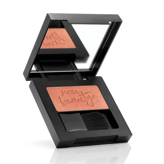 Jafra Perfume An opened hinged box of JAFRA Powder Blush, in the lid is a square mirror and the blush powder in a bar form on the bottom half of the box, the same space is shared with a small application brush that sits inside the box. The word JAFRA beauty is engraved